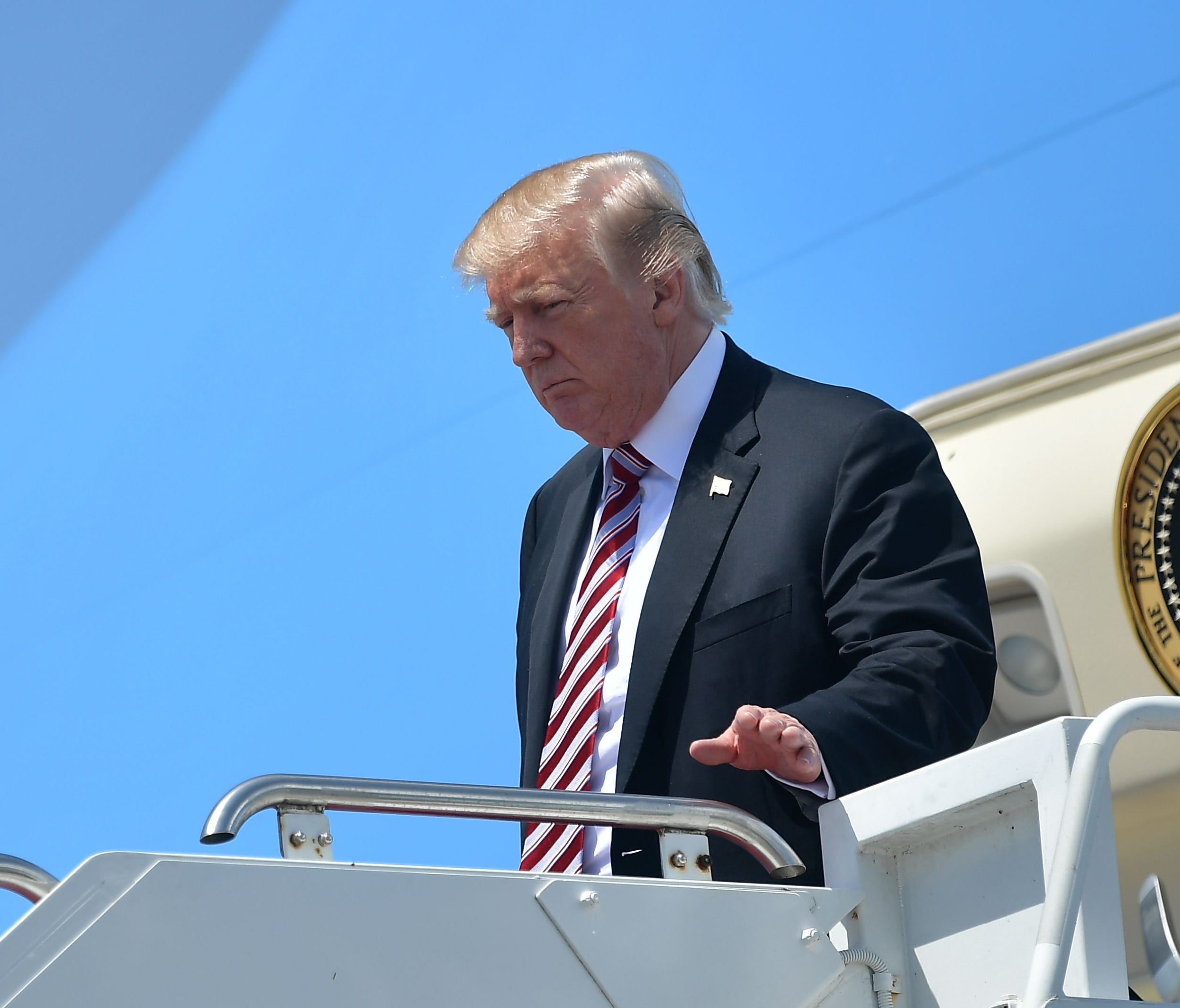 US President Donald Trump steps off Air Force One upon arrival at Palm Beach International in West Palm Beach, Florida on April 18, 2018. / AFP PHOTO / MANDEL NGANMANDEL NGAN/AFP/Getty Images ORIG FILE ID: AFP_1461PT