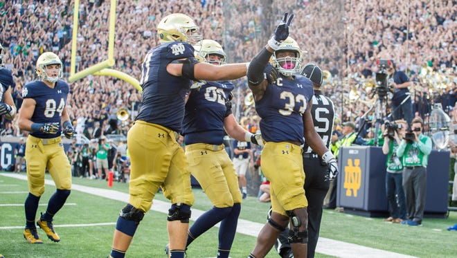 Notre Dame Fighting Irish running back Josh Adams (33) celebrates after a touchdown in the fourth quarter against the Temple Owls at Notre Dame Stadium.