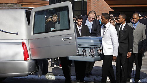 Members of the Silver Lake College basketball team carry the coffin of Stephen D. Smith during the funeral of Tyler Doohan, 9, Lewis J. Beach, and Smith as they leave St. John's of Rochester Catholic church in Fairport, N.Y. The three were killed by a fire in their mobile home. Fire officials say Tyler woke six other relatives and was killed when he tried to help his disabled grandfather, Smith. The story so touched the team that the players traveled through the night to act as pallbearers.