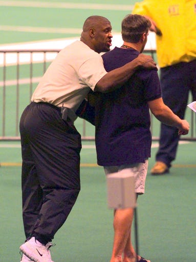 Reggie White jocks with Brett Favre while leaving the