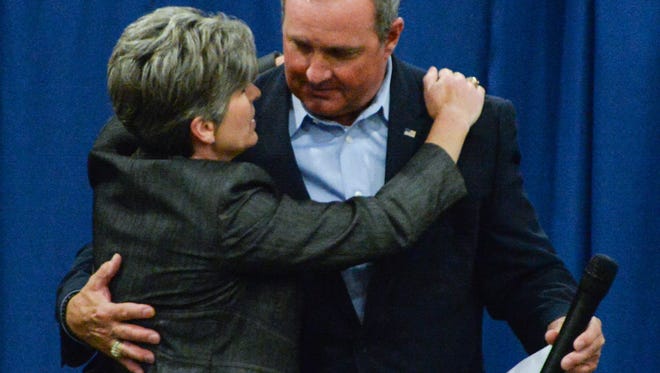 U.S. Sen. Joni Ernst, left, of Iowa hugs U.S. Rep. Jeff Duncan, right, after he introduced her as the featured speaker, during his Faith & Freedom barbecue campaign fundraiser at the Civic Center of Anderson on Monday.