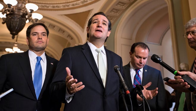 Sen. Ted Cruz, R-Texas, center, accompanied by Sen. Marco Rubio, R-Fla., left, and Sen. Mike Lee, R-Utah, right, express their frustration after the Senate passed a bill to fund the government, but stripped it of the defund "Obamacare" language as crafted by House Republicans,  on Sept. 27, 2013, on Capitol Hill in Washington.