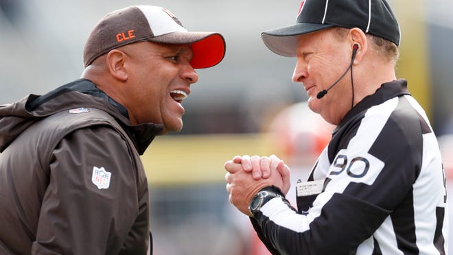 Cleveland Browns head coach Hue Jackson, left, talks with line judge Mike Spanier (90) along the sideline as his team plays against the Pittsburgh Steelers Sunday, Oct. 28, 2018, in Pittsburgh. The Steelers won 33-18. (AP Photo/Don Wright)