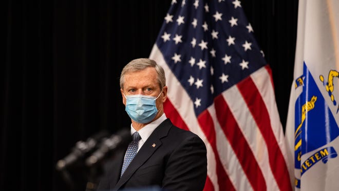 Gov. Charlie Baker stood behind a podium wearing a blue mask during a press conference where he and several cabinet secretaries detailed the state's response to the COVID-19 pandemic, Tuesday, Oct. 13, 2020.
