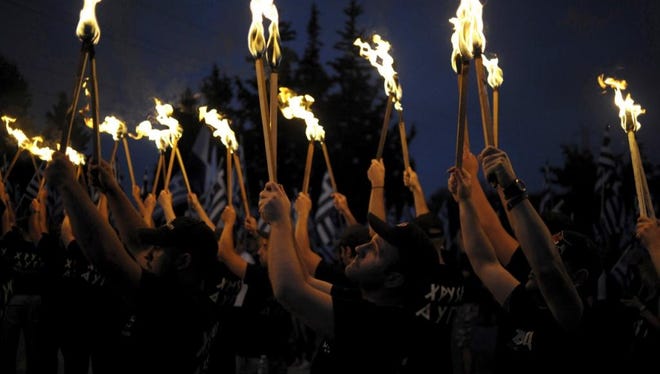 Far-right Golden Dawn supporters lifted torches outside Athens on Sept. 5.