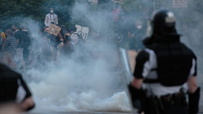 Sat. May 30, 2020; Columbus, OH, USA; Crowds disperse after Columbus Division of Police officers deployed tear gas as protests continue following the death of Minneapolis resident George Floyd on Saturday, May 30, 2020 in Columbus, Ohio. Floyd, a 46-year-old black man, was killed while in police custody after alledgely passing a counterfeit $20 bill at a conveinence store. Derek Chauvin, one of four Minneapolis police officers involved in Floyd's arrest, has himself been arrested and charged with third-degree murder and manslaughter. During the arrest, video footage showed Chauvin kneeling on Floyd's neck for about nearly nine as Floyd repeatedly said "I can't breathe."