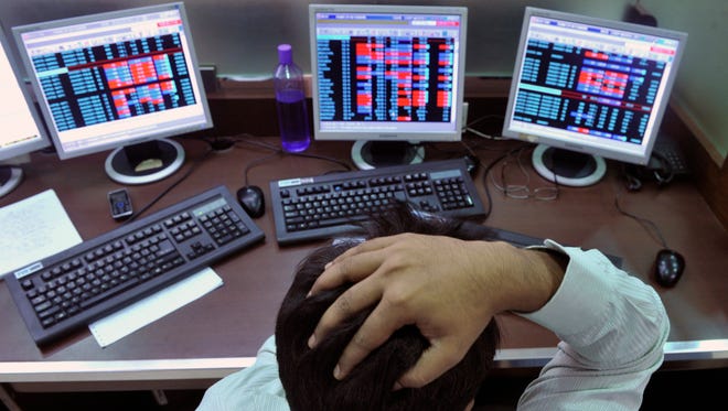 An Indian stockbroker reacts as he watches share prices on his computer during intraday trade at a brokerage firm in Mumbai on August 3, 2011. Indian shares slid as much as 1.23 percent and below the 18,000-point level in early trade August 3, tracking regional markets on concerns of a weakening global outlook. The benchmark 30-share Sensex index on the Bombay Stock Exchange fell 223.32 points to a day's low of 17,886.57, before recovering marginally to 17,943.47 but still down 0.92 percent. AFP PHOTO/Indranil MUKHERJEE (Photo credit should read INDRANIL MUKHERJEE/AFP/Getty Images) ORIG FILE ID: Del493403
