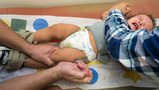 A 1-year-old boy is given the 
measles-mumps-rubella vaccine.