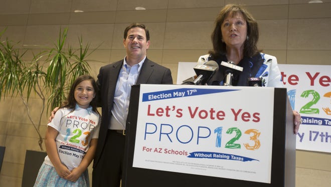Gov. Doug Ducey with Sharon Harper (right), chairwoman of Greater Phoenix Leadership, and Finn Wallace in Phoenix after hearing Proposition 123 passed, on May 19, 2016.