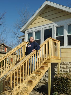 Terry Lewis stands on her new steps at the front entrance to her Crisfield home in this photo from 2014. Lewis' home was damaged during Hurricane Sandy and was the first house rehabbed with federal Community Development Block Grant funds sent to Somerset County for hurricane recovery efforts.