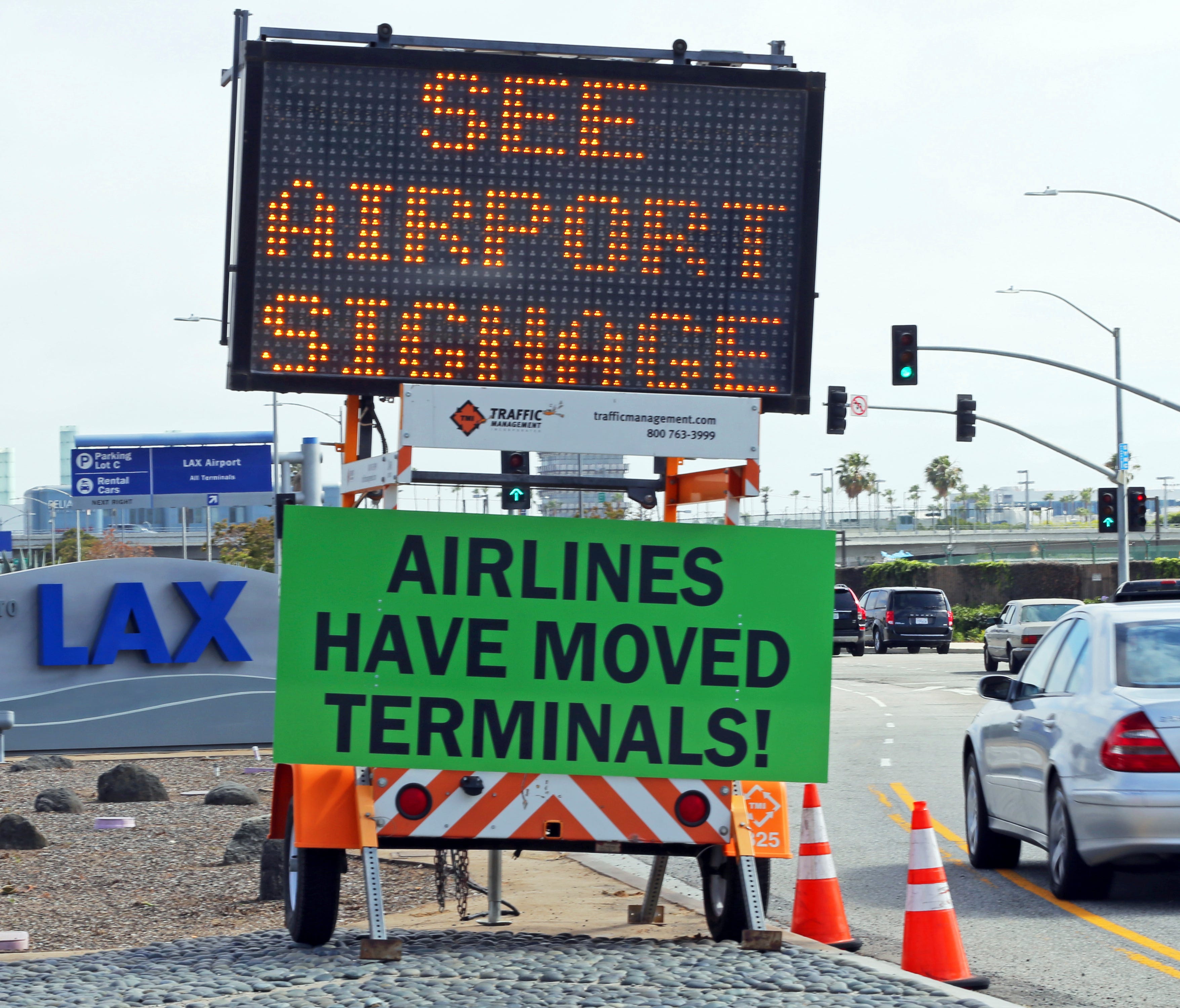In this photo from Thursday, May 11, 2017 photo, warning signs advise travelers that their airline's terminal may change as they approach Los Angeles International Airport.