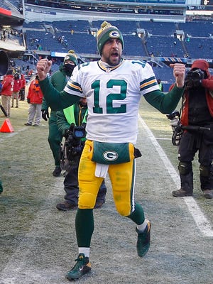 Green Bay Packers quarterback Aaron Rodgers pumps up the crowd while leaving the field after a last-second field goal.