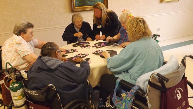 At Rivergate Health Care Center in Riverview, residents make Halloween cats for an activity on Wednesday. Clockwise from lower left are Pat Gill, Pat Kozikowski, Lorena Debolt, activity director Jamie Bridges, Lorrie Delo and Jackie Kadari. The center was awarded Facility of the Year Award for its Northeast Division by Life Care Centers of America.