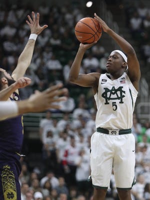 Michigan State Spartans guard Cassius Winston scores against Notre Dame guard Matt Farrell in the first half Thursday, Nov. 30, 2017 at the Breslin Center in East Lansing.