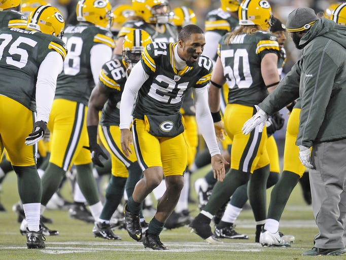 Green Bay Packers Charles Woodson (21) greets teammates