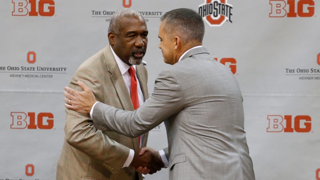 Ohio State athletic director Gene Smith, left, shakes hands with Chris Holtmann after naming Holtmann the new men's head basketball coach at Ohio State, Monday, June 12, 2017, in Columbus, Ohio. (AP Photo/Jay LaPrete)