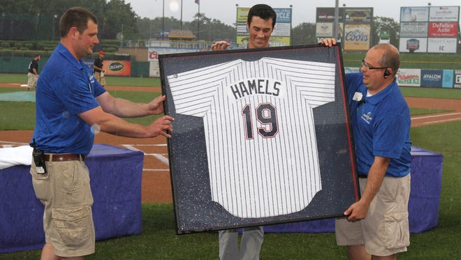 Assuming the permanent role of general manager for the Lakewood BlueClaws is Chris Tafrow (left), shown presenting a jersey to Cole Hamels during a ceremony to retire his number at FirstEnergy Park.