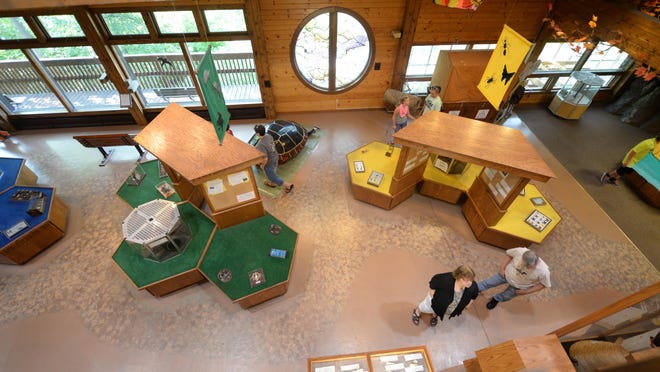 Visitors walk through the main level of the Nature Center at Bay Beach Wildlife Sanctuary on Thursday, July 9, 2015.