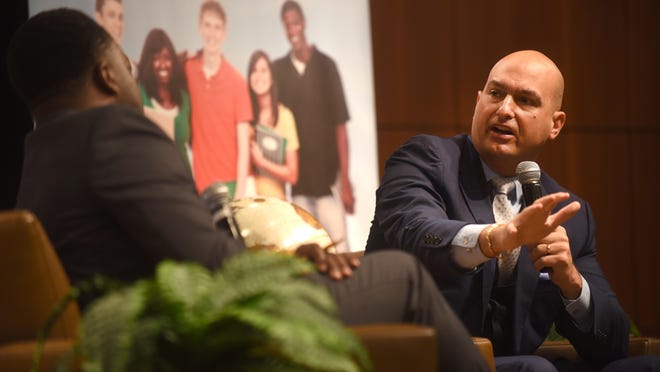 Nikolai Vitti, right, Superintendent, Detroit Public Schools, speaks to Bankole Thompson during the "State of Education in Detroit" held at Wayne Community College District's downtown campus on Tuesday August 22, 2017.