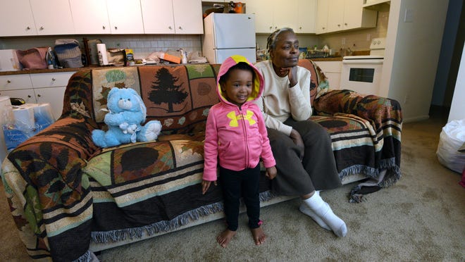 Alyce Ali and granddaughter Ariana Ali sit on a new sofa at the Oak Ridge Apartments in Runnemede where they are living after the partial collapse of their Camden home.