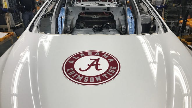A car with a University of Alabama logo rolls off the assembly line Monday at the Hyundai plant in Montgomery.