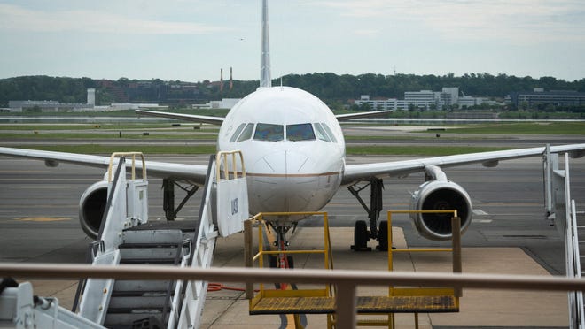 A United Airlines jet sits at the gate at Ronald Reagan Washington National Airport. United said it is starting to add back flights lost to fears of the coronavirus pandemic.
