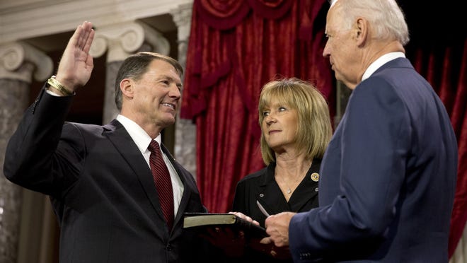 Vice President Joe Biden administers the Senate oath to Sen. Mike Rounds R-S.D., with wife, Jean Rounds, during a ceremonial re-enactment swearing-in ceremony Tuesday in the Old Senate Chamber of Capitol Hill in Washington.