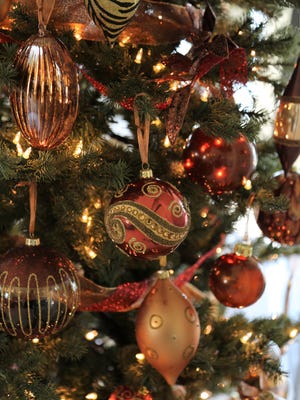 Gold ornaments adorn the family room Christmas tree.