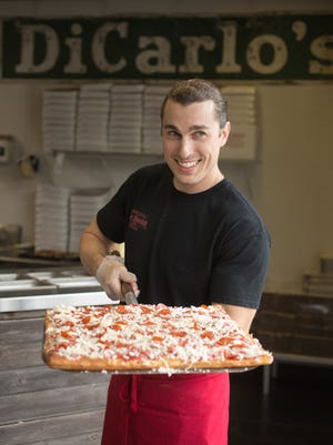 Nick Drakos with a 16 cut pizza from DiCarlos in Hilliard