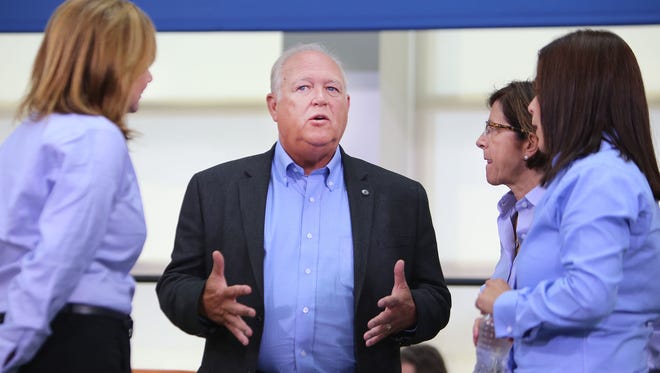 Following the ceremonial handshake between General Motors and United Auto Workers Monday, July 13, 2015 at the UAW-GM Center for Human Resources in Detroit, UAW President Dennis Williams, center, talks as General Motors President  Mary Barra, left,  listens along with   General Motors North America Vice-President Cathy Clegg, second from right,  and UAW Vice-President for General Motors Cindy Estrada.