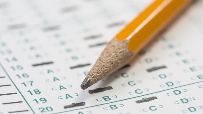 Close up of a standardized testing answer sheet with a pencil resting on it with a shallow depth of field