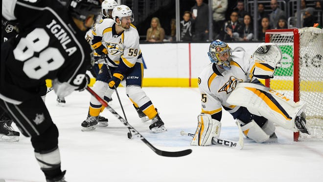 Los Angeles Kings right wing Jarome Iginla, left, scores on Nashville Predators goalie Pekka Rinne, of Finland, in overtime of an NHL hockey game, Thursday, March 9, 2017, in Los Angeles. The Kings won 3-2. (AP Photo/Mark J. Terrill)