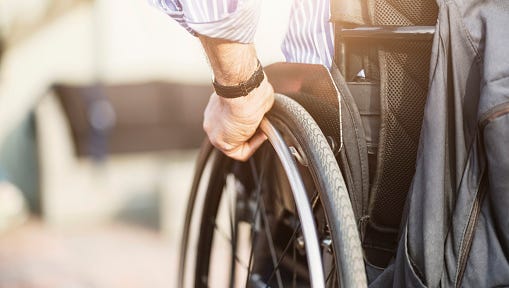 Cropped image of man in wheelchair outdoors