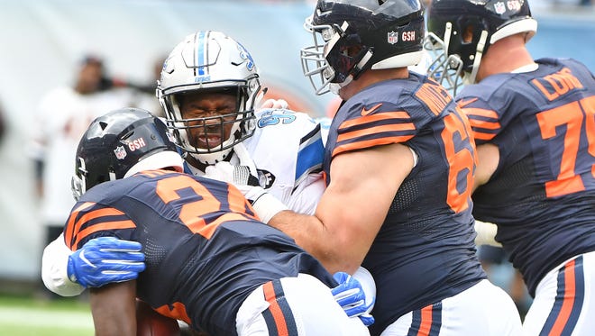 The Lions' Tyrunn Walker stops Bears running back Jordan Howard at the line of scrimmage in the first quarter.
