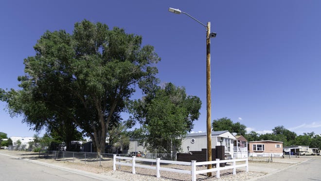A camera meant to catch illegal dumping activity sits atop a utility pole on Pueblo's East Side as part of a larger effort by the Pueblo Trash Task Force