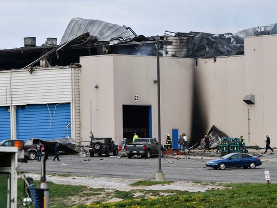 Emergency personnel work at the scene of a fire at