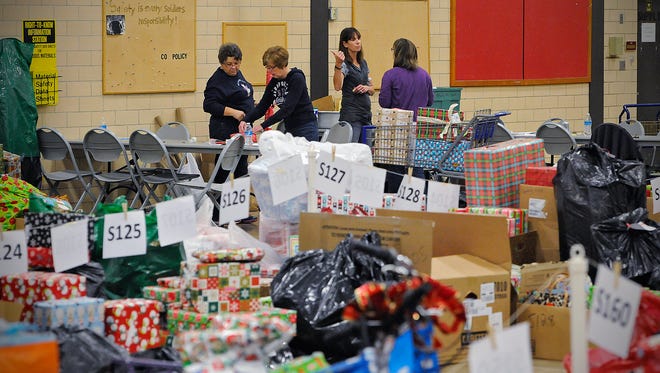 Volunteers wrap the last few gifts for the Catholic Charities Share the Spirit Program in December 2014 at the St. Cloud Armory.