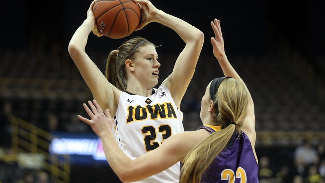 Iowa's Christina Buttenham looks for an open teammate during the Hawkeyes' game against Western Illinois at Carver-Hawkeye Arena on Thursday, Nov. 19, 2015.