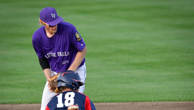 Little Falls' Adam Hallberg watches the ball skip away after a throw in the dirt to second that left the 76ers' Chris Backes (18) safe in the third inning of the Sub-State 12 American Legion baseball final Friday, July 22, at Dick Putz Field.