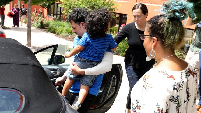 Ever Reyes Mejia of Honduras puts his 3-year-old son into a car shortly after his reunification with him after being separated for three months. The reunion happened inside the U.S. Customs and Immigration Enforcement in Grand Rapids on Tuesday, July 10, 2018.