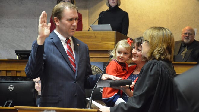 Brian Buchanan, left, is sworn in as an Indiana senator Monday by Indiana Supreme Court Justice Loretta Rush, as Buchanan's wife, Elisha, looks on. Buchanan will represent District 7, which includes parts of six counties, including Tippecanoe County. He replaces Brandt Hershman, R-Buck Creek, who resigned after 18 years to take a job in Washington, D.C.