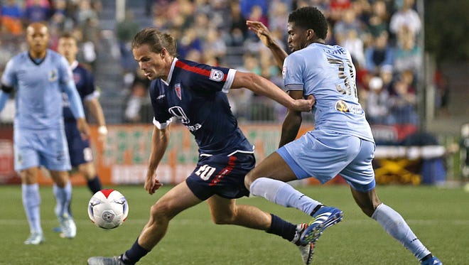 Indy Eleven forward Justin Braun (20) pushes past Minnesota United FC defender Damion Lowe (31) in the second half of the Indy Eleven's game against Minnesota United FC at IUPUI's Carroll Stadium, Indianapolis, Saturday, May 21, 2016.