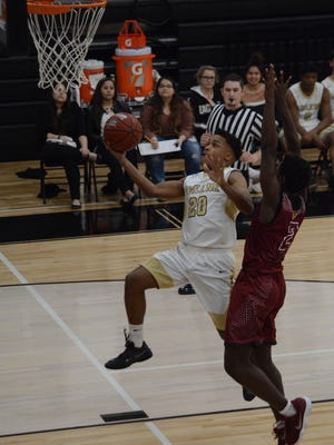 Abilene High's Jordan Booker goes up for a breakaway layup while being defended by Keller Central's Jerome Whitaker during the Eagles' 54-51 loss Friday at Eagle Gym.