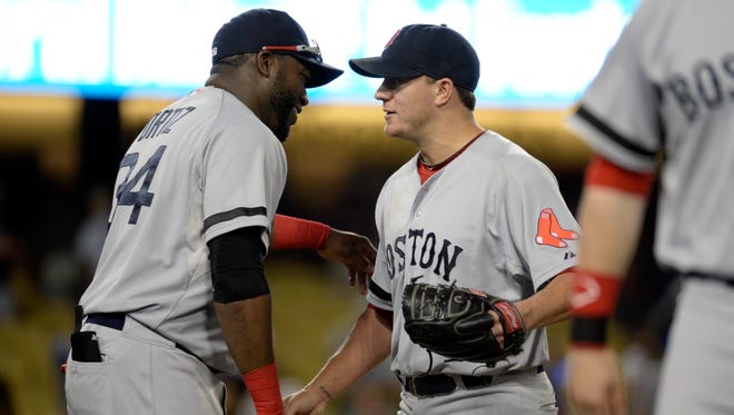 Boston Red Sox designated hitter David Ortiz shakes hands with starting pitcher Jake Peavy after Peavy pitched a complete game against the Los Angeles Dodgers.