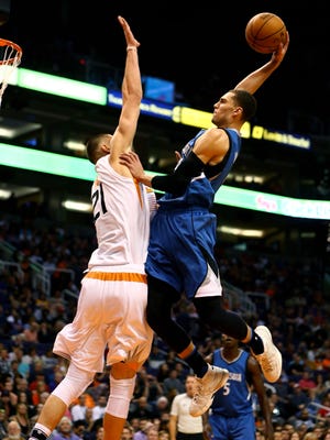 Nov 25, 2016; Phoenix, AZ, USA; Timberwolves guard Zach LaVine (right) goes up for a dunk over Suns center Alex Len in the first quarter at Talking Stick Resort Arena.