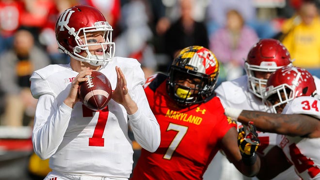 Indiana quarterback Nate Sudfeld, left, looks for a receiver as he is pressured by Maryland defensive lineman Yannick Ngakoue (7) in the first half of an NCAA college football game, Saturday, Nov. 21, 2015, in College Park, Md. (AP Photo/Patrick Semansky)