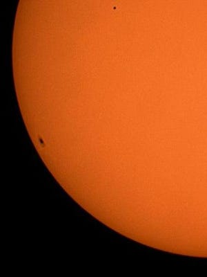 This image shows Mercury transit as seen from the New Mexico Museum of Space History patio taken on Nov. 8, 2006. It was taken by local astronomer Jim Tomaka. Mercury is the small dot in the upper middle of the photo and is dwarfed by the sunspot in the lower left. Photo courtesy of the Amateur Astronomers Group.