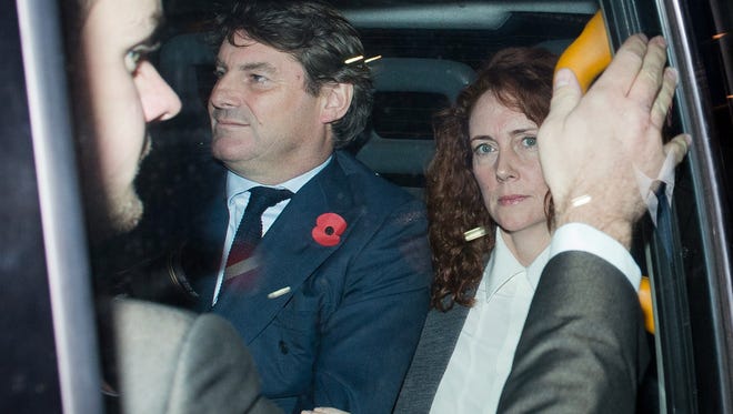 Rebekah Brooks, former News International chief executive, and her husband Charlie  leave the Old Bailey court in London on Thursday.