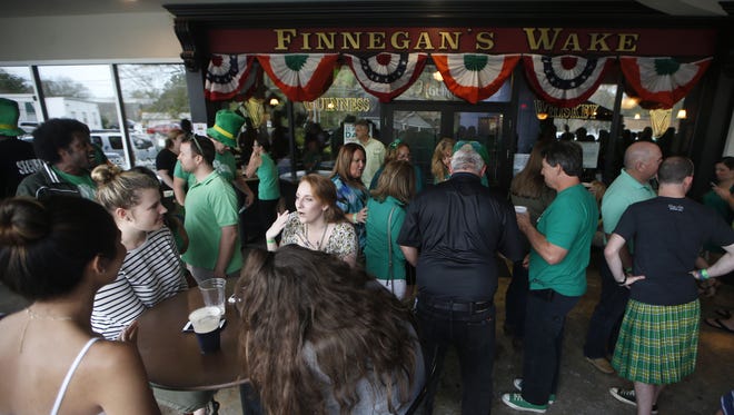 Patrons celebrate St. Patrick's Day at Finnegan's Wake in the Midtown neighborhood.