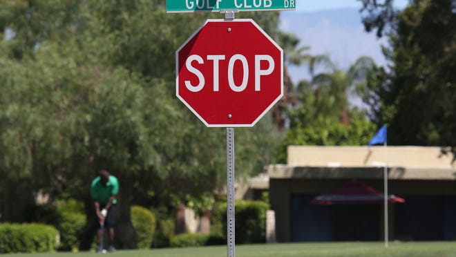 A golfer putts at Tahquitz Creek Golf Resort near a sign on Golf Club Drive which will soon be changed to Lawrence Crossley Road in honor Lawrence Crossley, an early African American resident Palm Springs and pioneer.